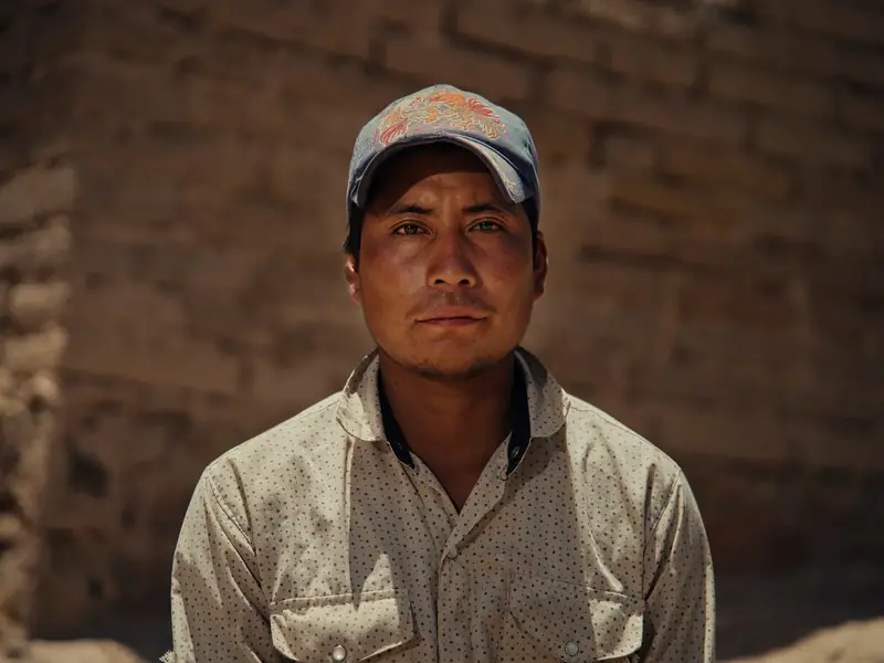 Worker portrait against an adobe wall in a documentary