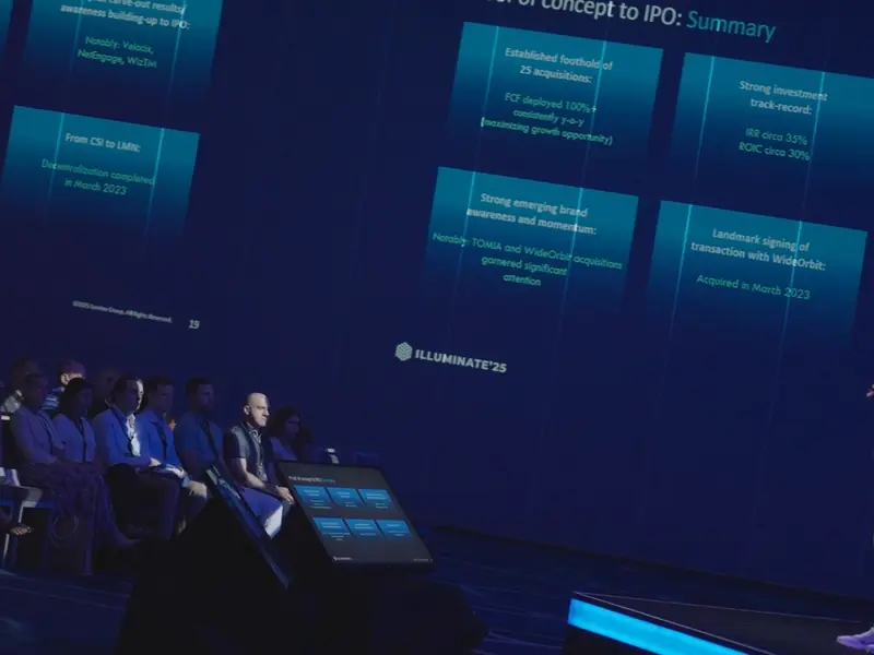 Conference audience and speaker on a blue stage