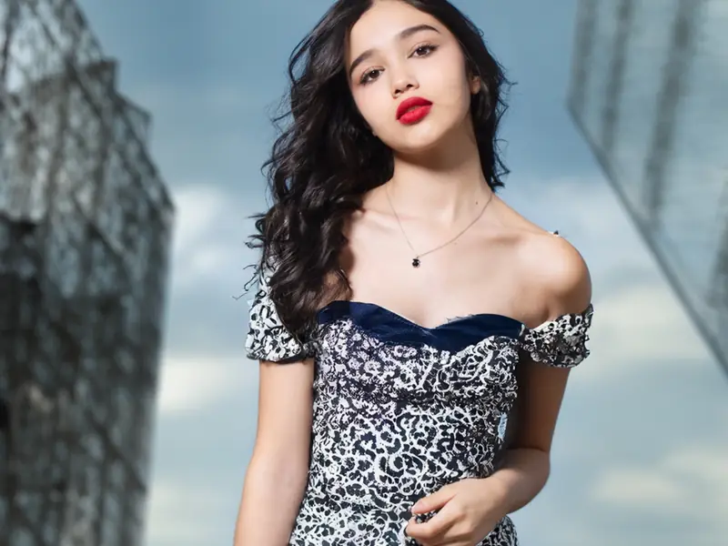 Composited fashion shot against a city building
