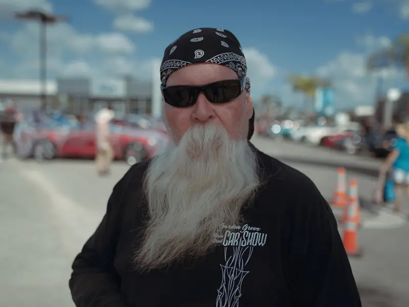 Bearded man interviewed on a street for a news crew