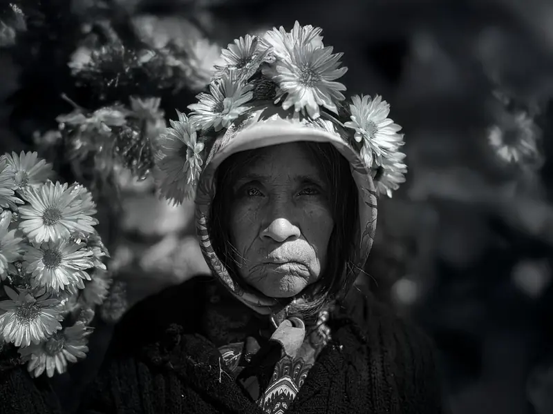 Black and white portrait with flowers, news feature