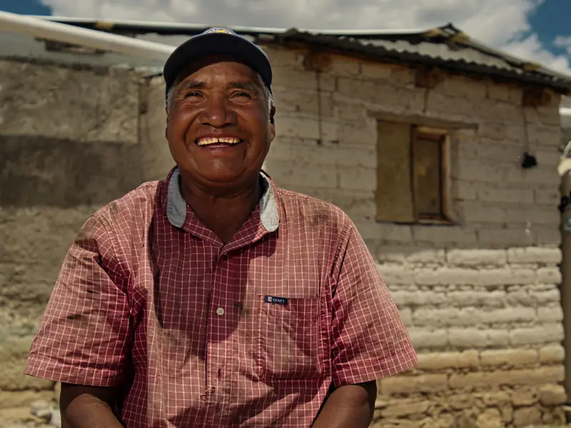 Local man smiling in a village street for a short video